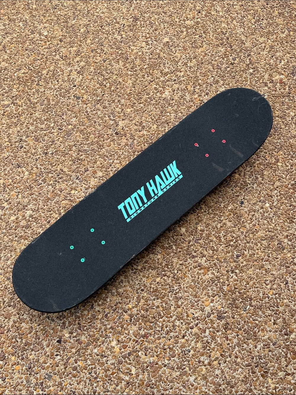 Tony Hawk Black Skateboard Deck with Teal Logo and Red Hardware